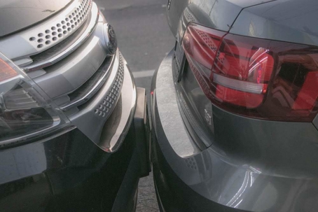 Two cars touching bumpers
