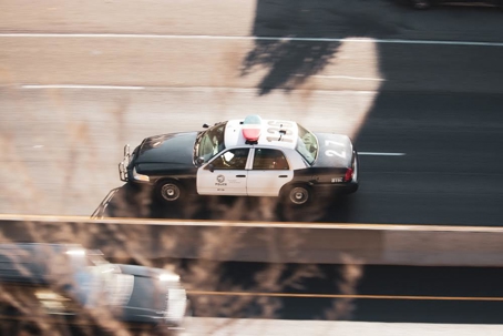 The image shows a black and white police car