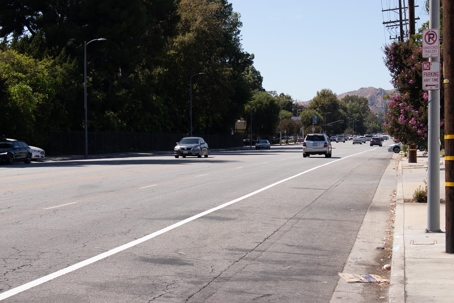Vehicles drive on a four lane road