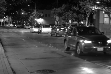 A black and white photograph illustrates cars on Ward Hill Rd at night, likely a high-traffic area