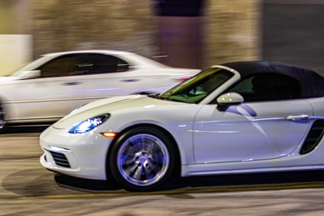 Blurred, white convertible Porsche
