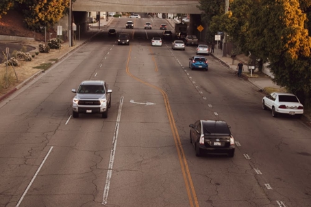 A street view shows cars driving in both directions