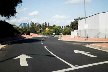 Asphalt roadway with painted white arrows