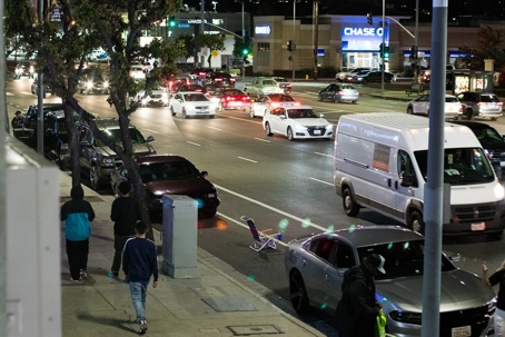 A city street is packed with cars at night