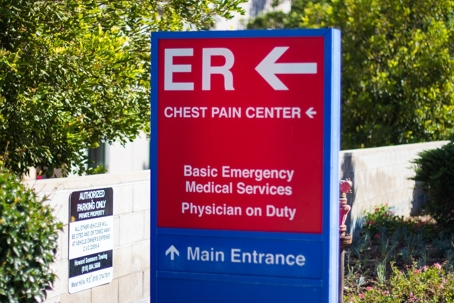 A sign for the ER points left, with "Chest Pain Center" and "Main Entrance"